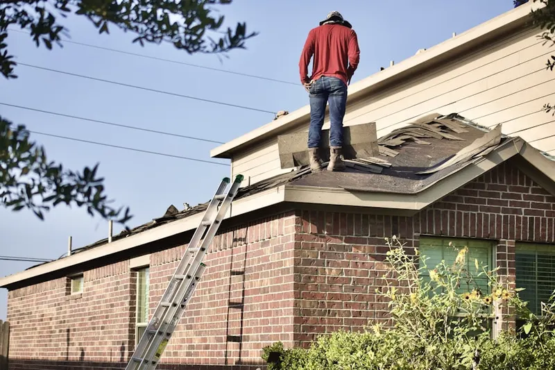 Professional roofer working on a residential roof in Colonial Park Farms
